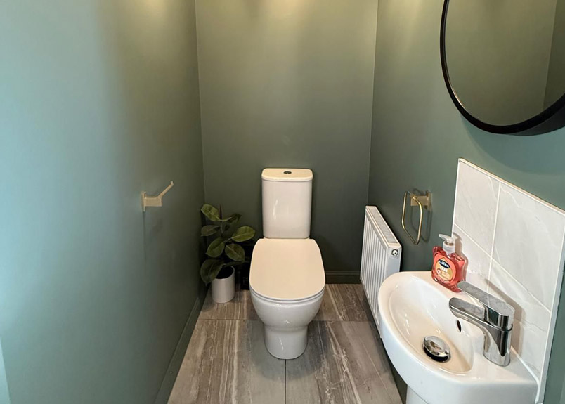 Painted hallway and staircase in Aylesbury with neat woodwork and bannisters